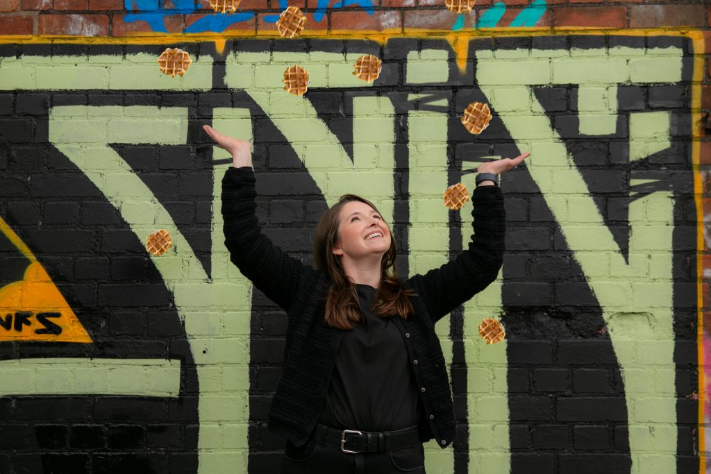 Lily Attwell-Rowan throwing waffles into the air in a playful moment